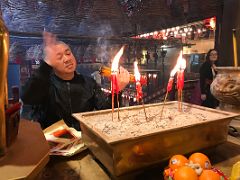 06B People offer incense sticks, candles and fruit at Man Mo Temple Hong Kong